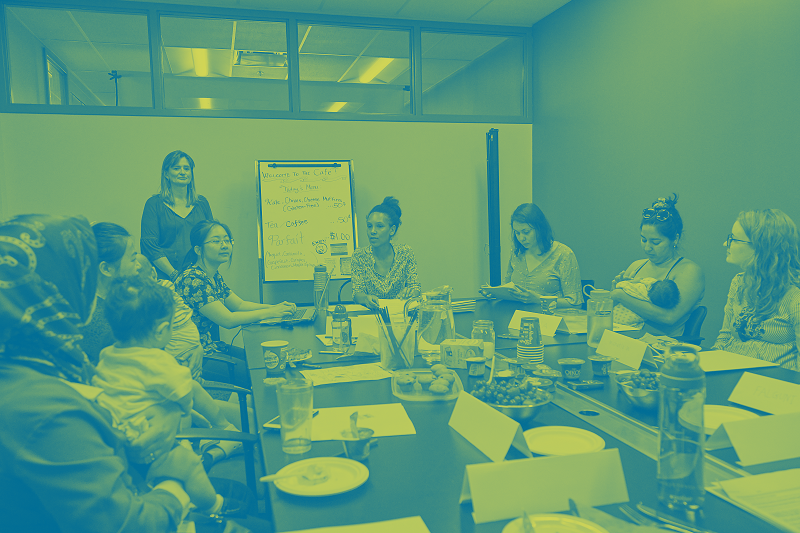 McMaster researcher Tina Moffatt's Moms to Babies project - image shows a focus group with parents and babies sitting around a table discussing nutrition